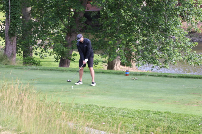Male gofer teeing off