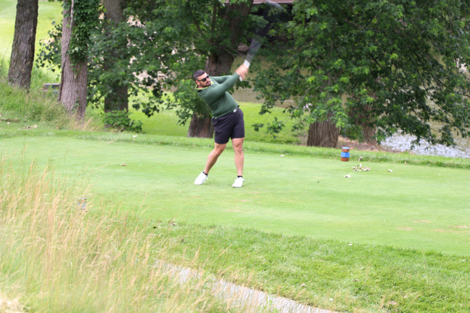 Golfer teeing off