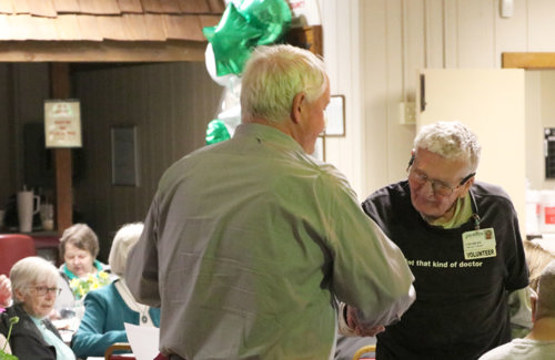 Mike Swick giving volunteer Charles his award