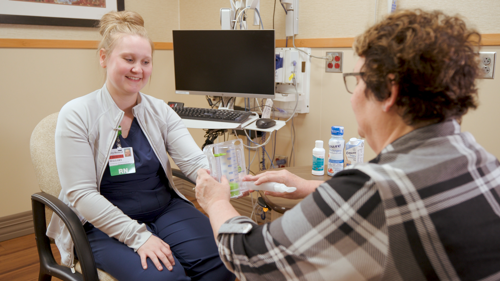 Nurse showing patient how to use an Incentive Spirometer