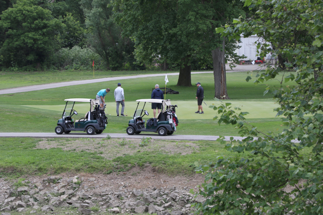 2 golf carts with golfers