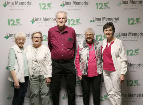 Volunteers in front of 125 years backdrop
